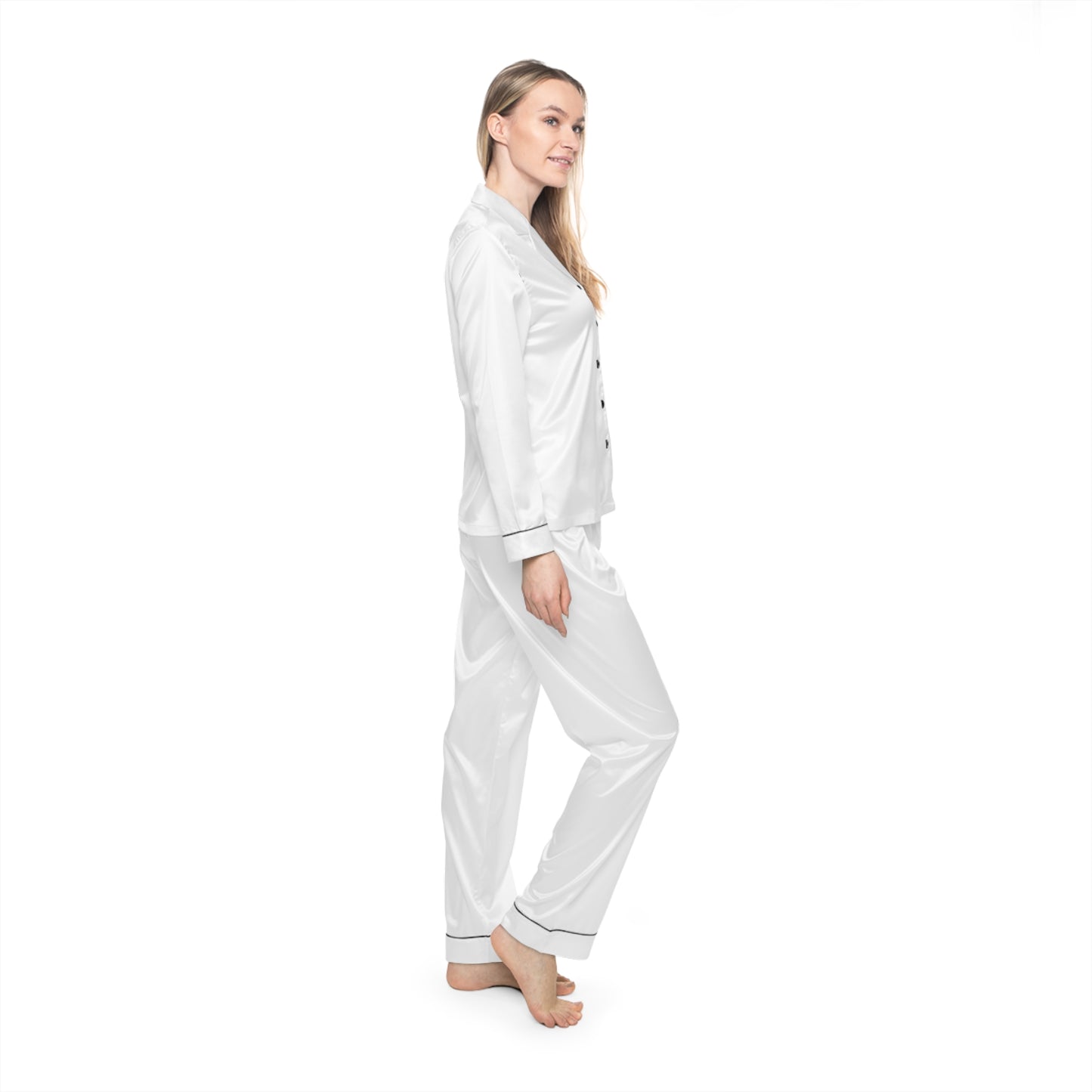 Profile view of woman wearing white Soft & Sleek satin pyjamas, standing against white background.