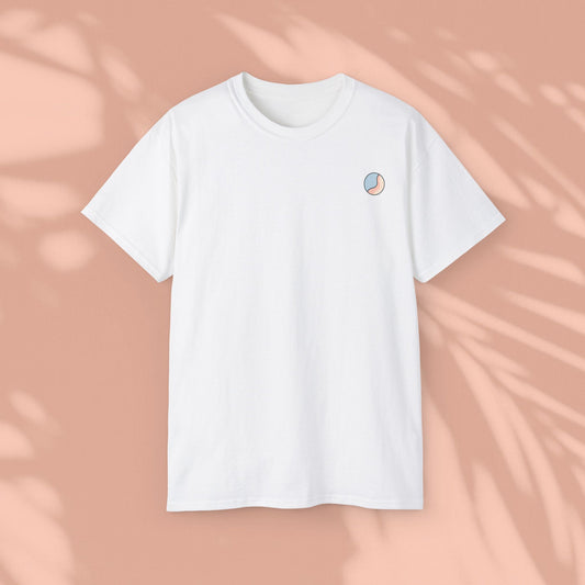 White Soft & Sleek t-shirt with circular emblem on chest, peach background