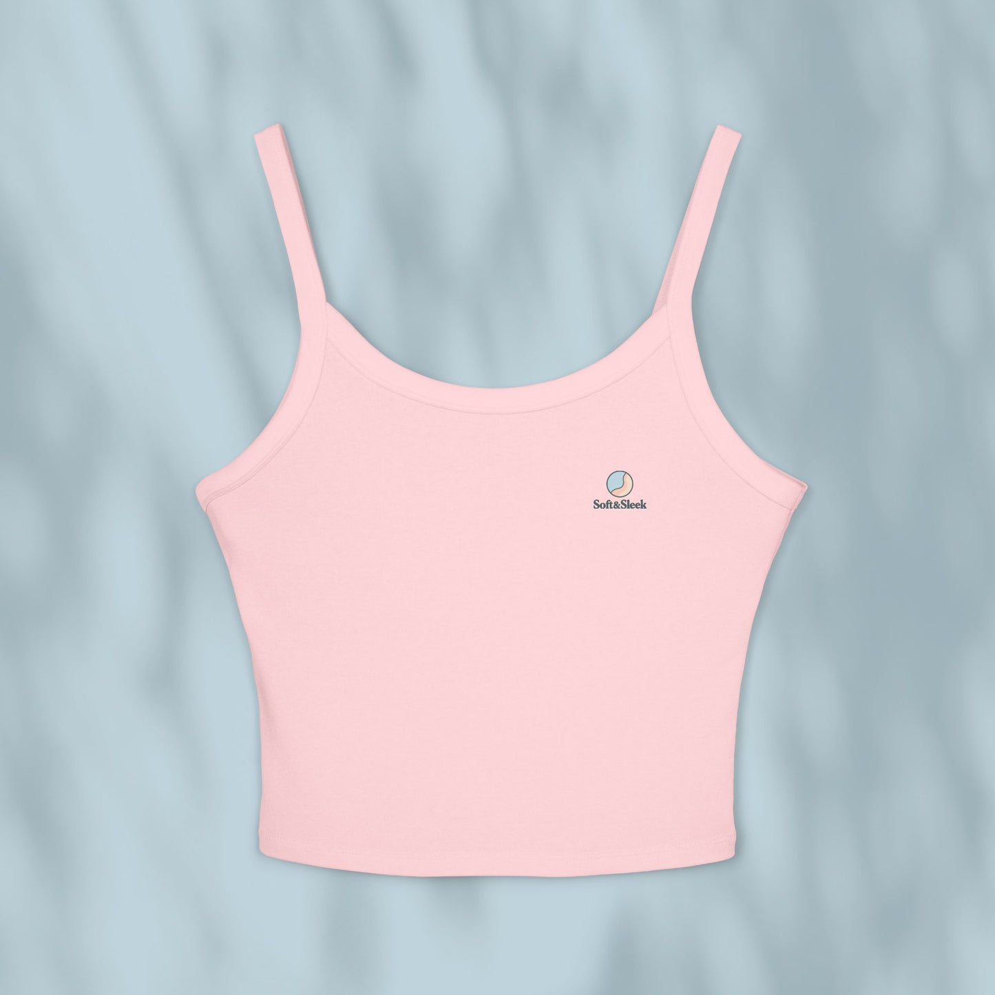 Pink tank top with a brand logo on a light blue background