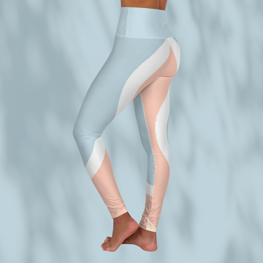 Side view of cropped leggings showing wave-shaped white and peach panels wrapping from hip to shin, pale blue background