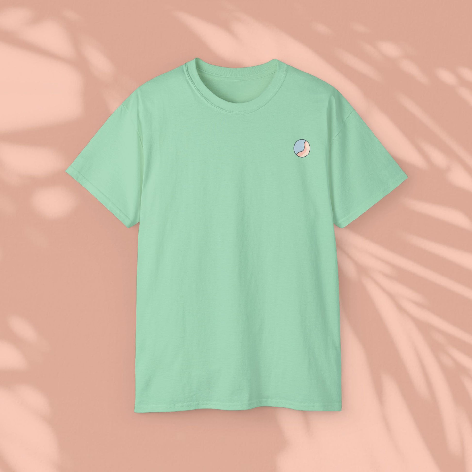 Mint green Soft & Sleek t-shirt, plain front, peach background