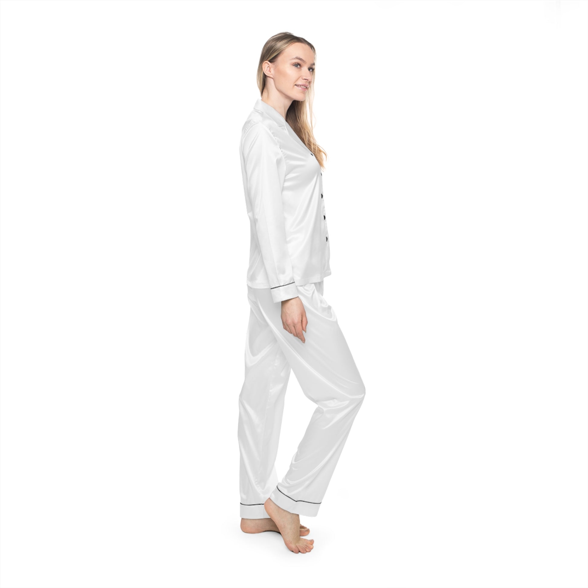 Profile view of woman wearing white Soft & Sleek satin pyjamas, standing against white background.