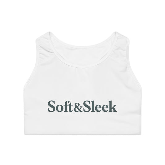 Flat lay front view of white Soft & Sleek sports bra with large printed logo on chest