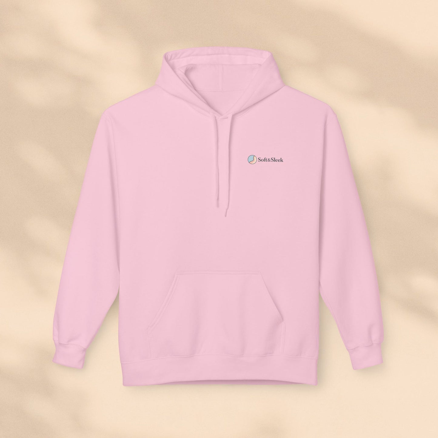 Pink hoodie with a brand logo on a beige background