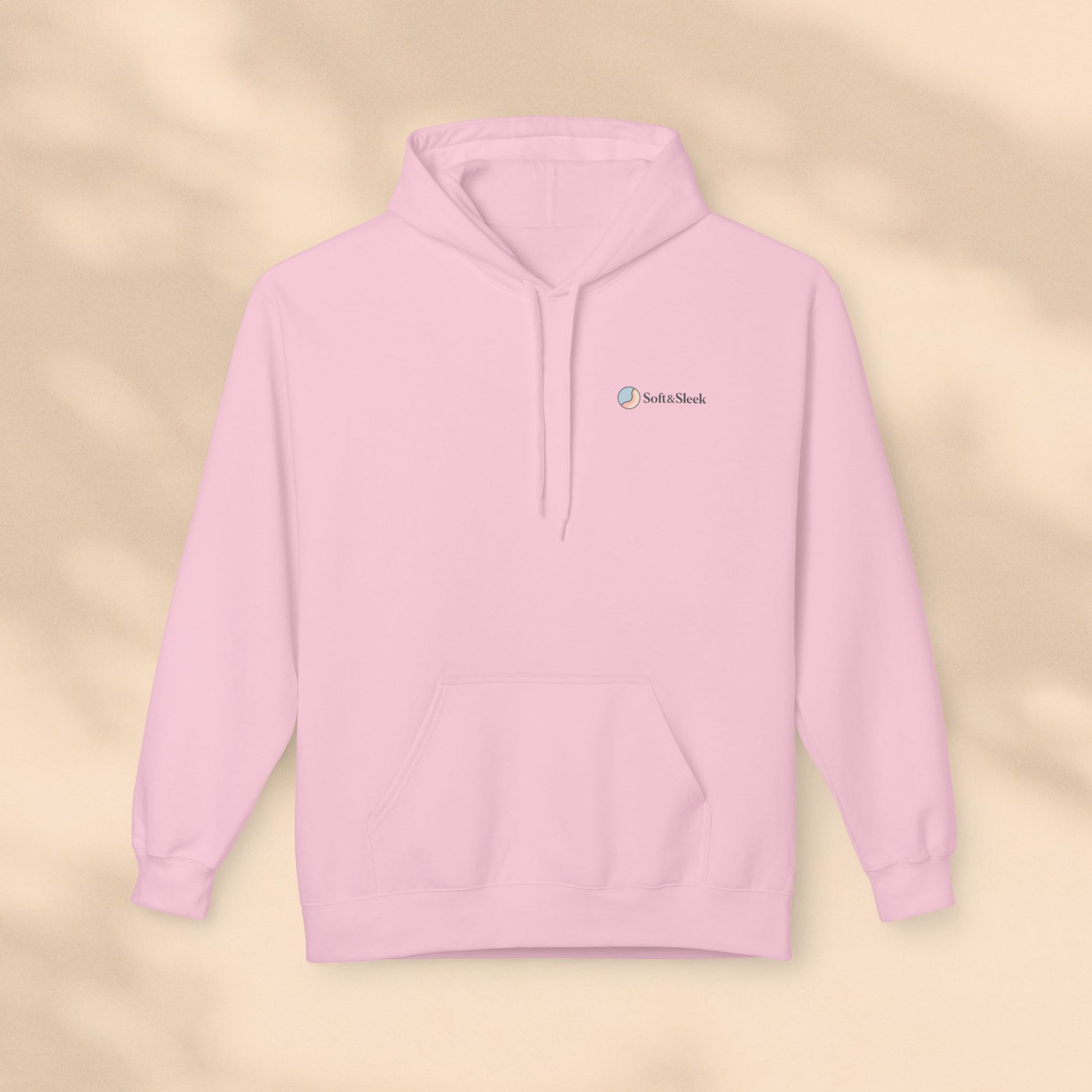 Pink hoodie with a brand logo on a beige background