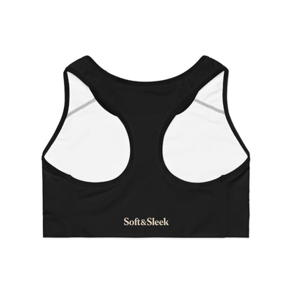 Flat lay back view of black Soft & Sleek sports bra showing white inner lining and racerback cut with logo on band.
