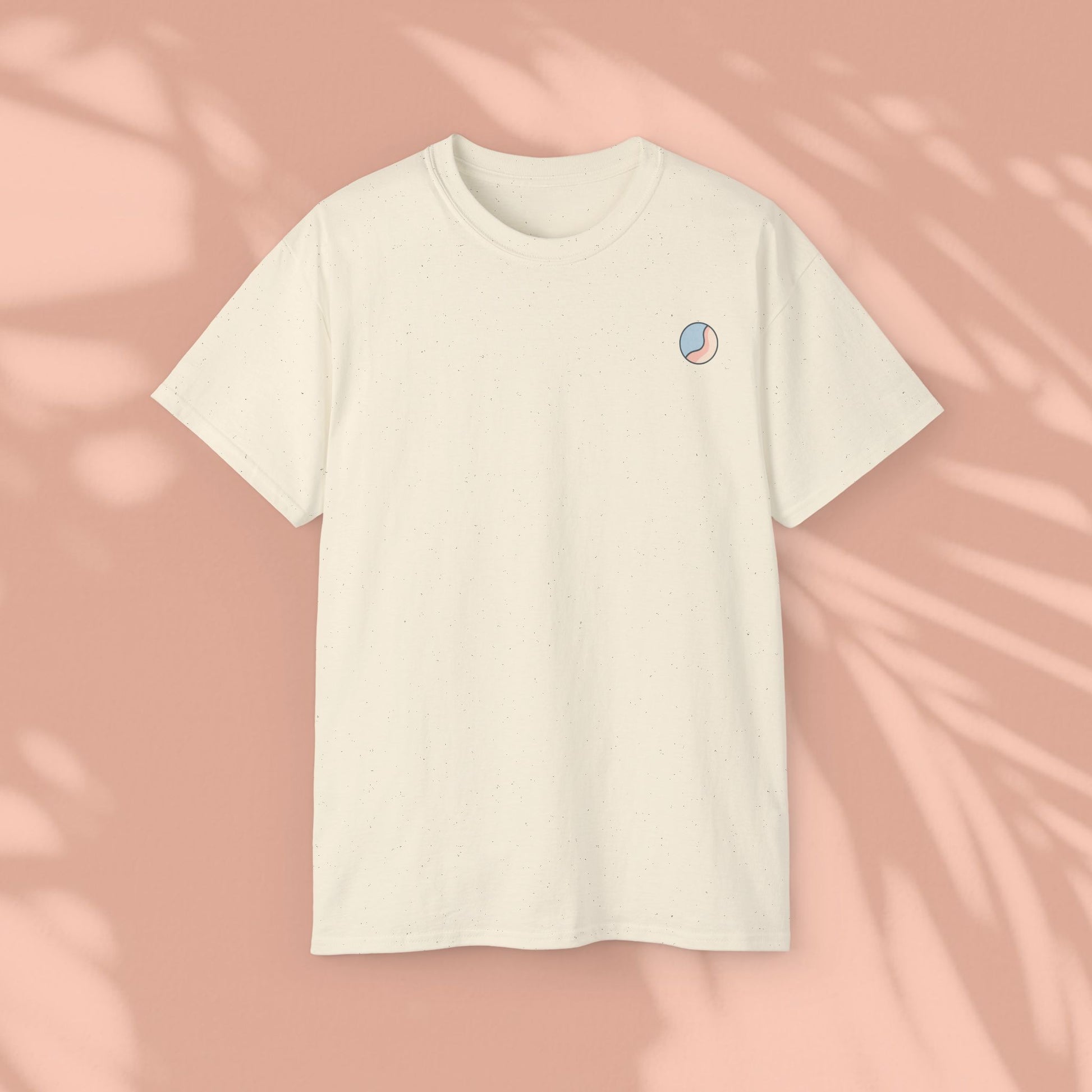 Beige Soft & Sleek t-shirt with circular emblem, peach background