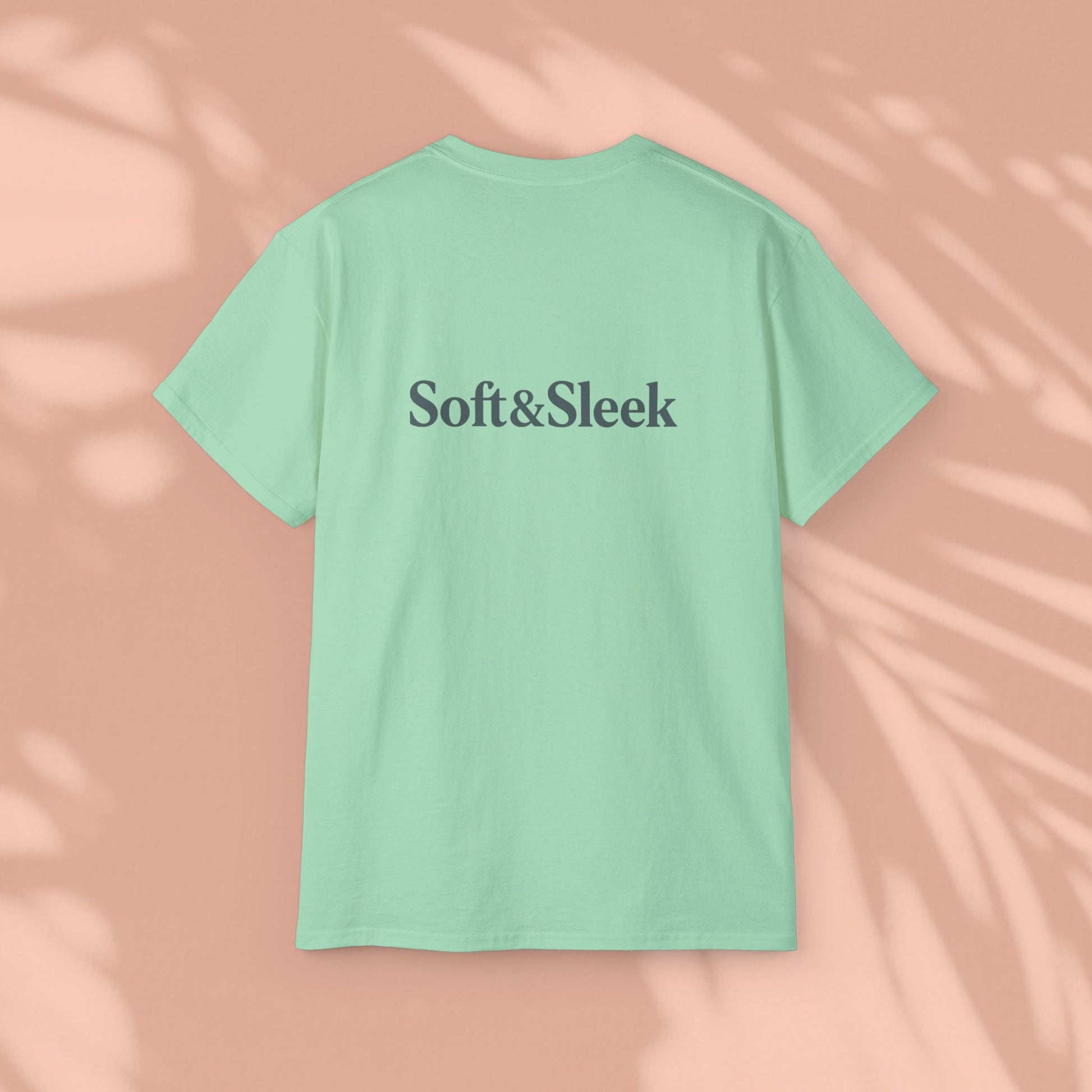 Green Soft & Sleek t-shirt with logo on back, peach background