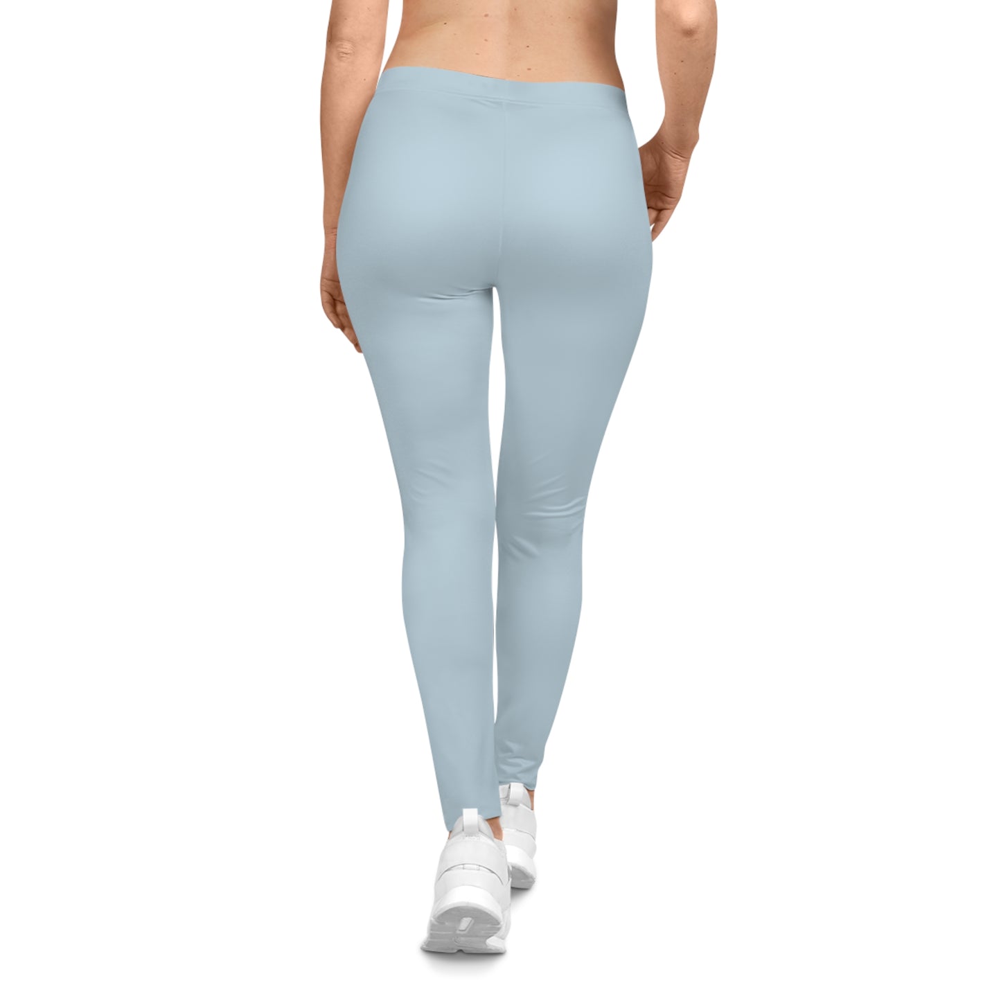 Rear view of woman in light blue Soft & Sleek leggings and white trainers