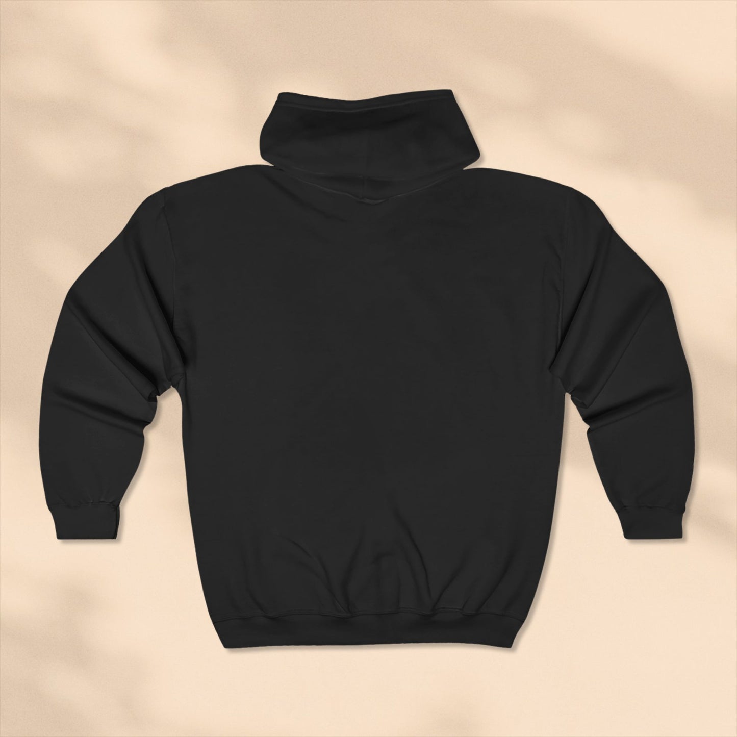 Rear view of Black hoodie on a beige background