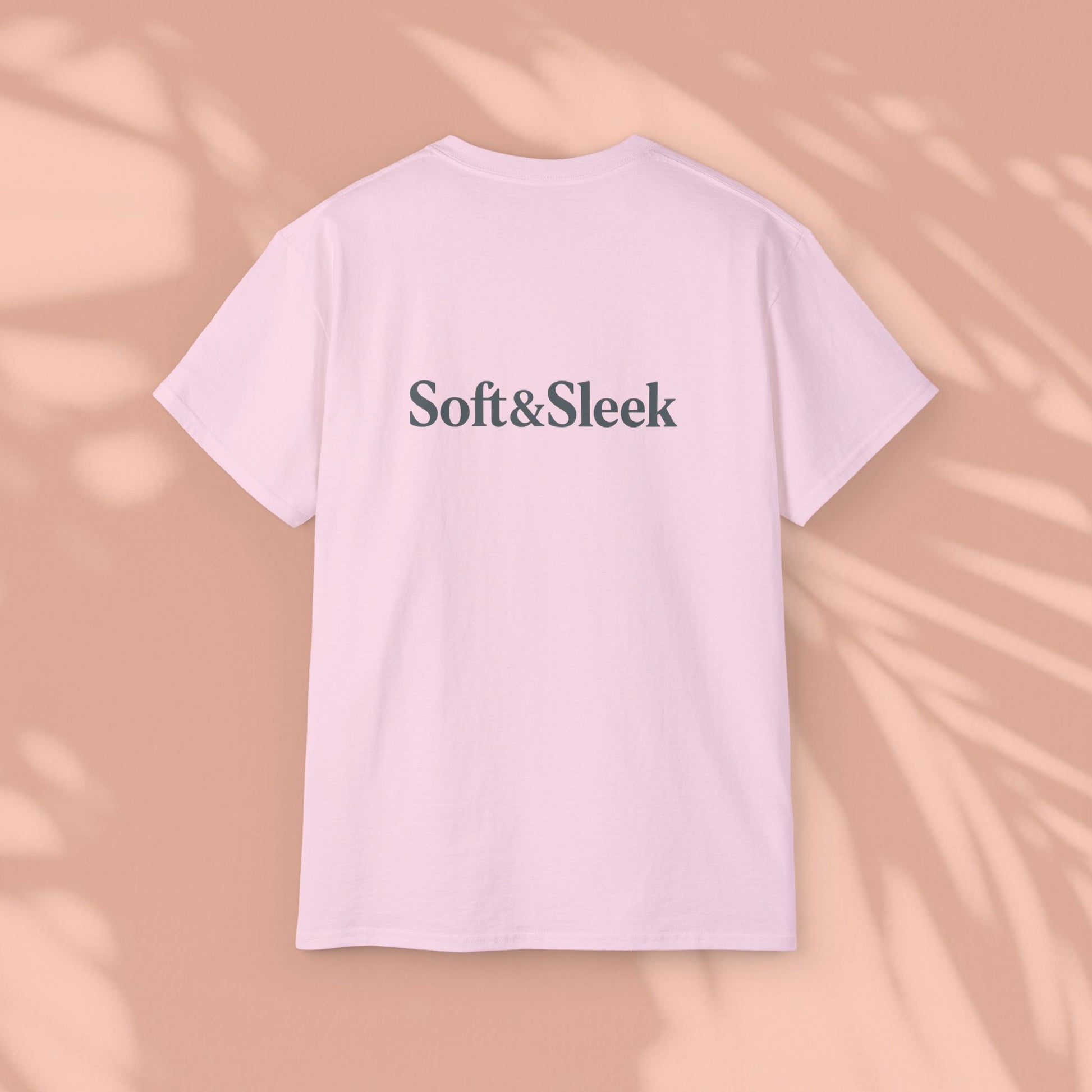 Pink Soft & Sleek t-shirt with logo on back, peach background