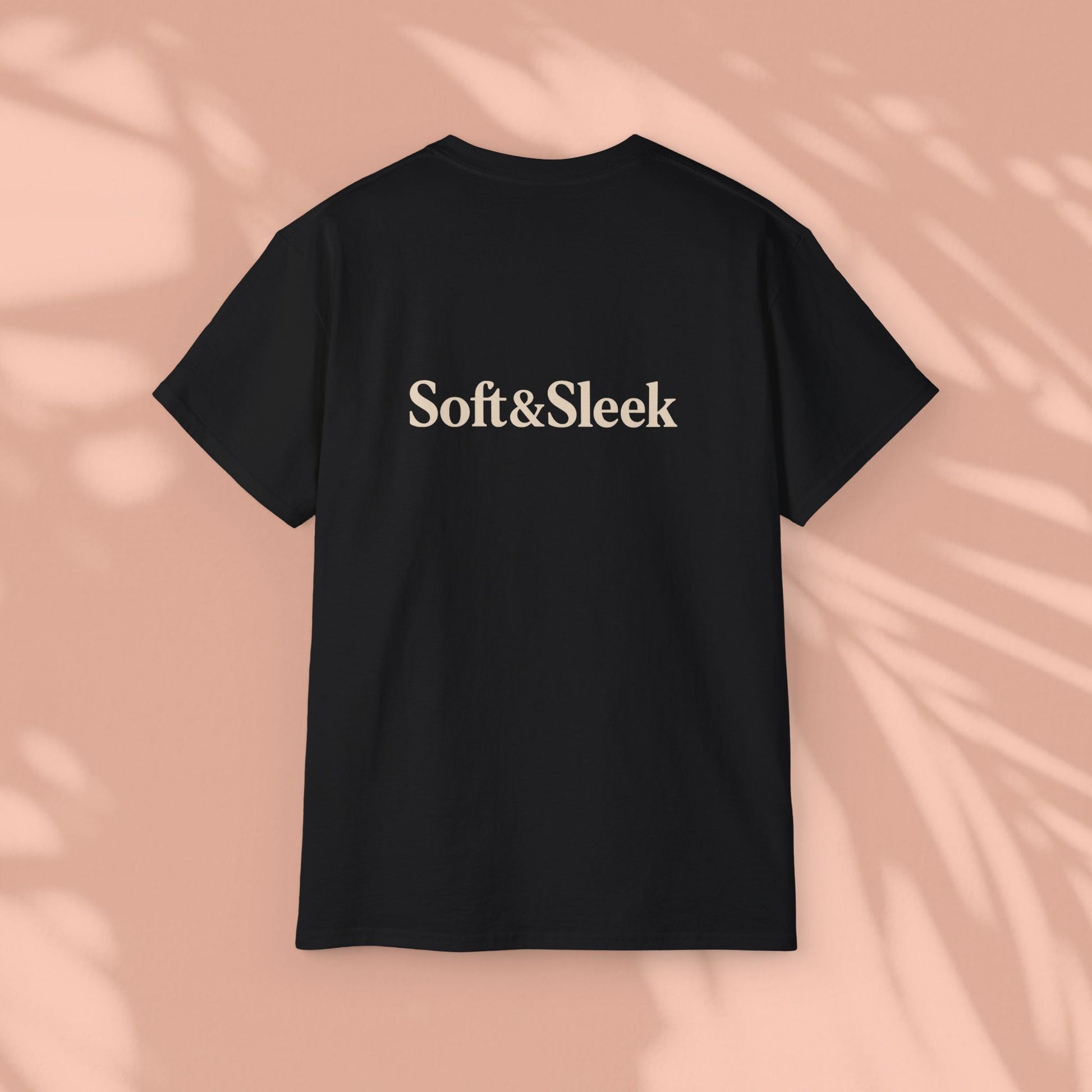 Black Soft & Sleek t-shirt with logo on back, peach background