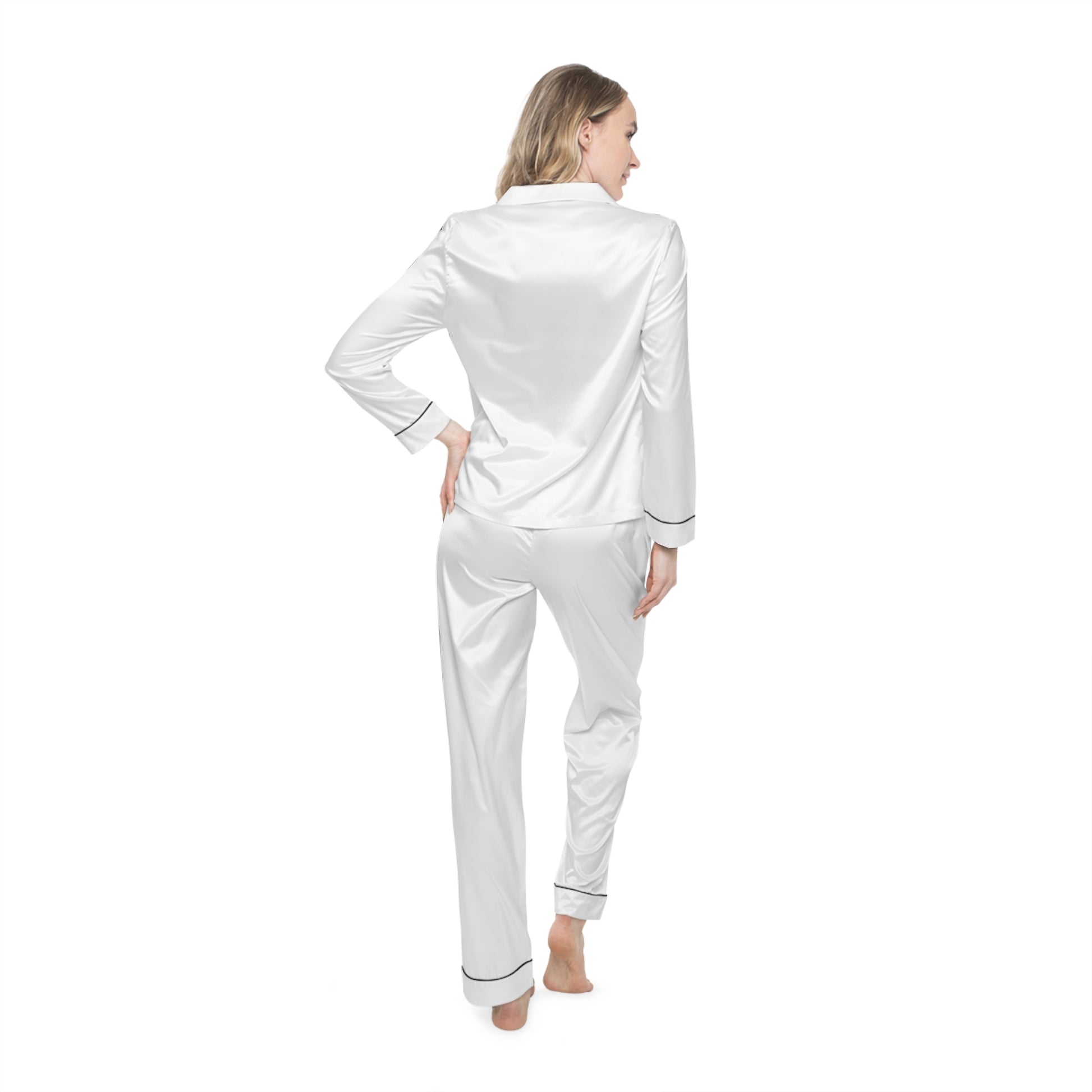 Rear view of woman in white Soft & Sleek satin pyjamas with hands on hips.