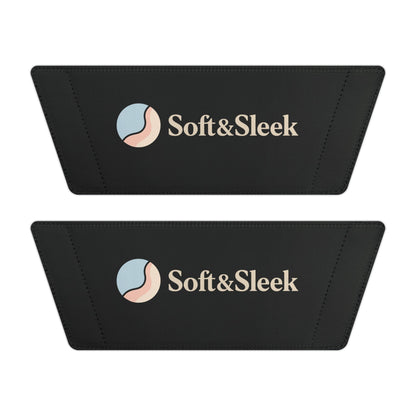 Flat lay of two black Soft & Sleek slide straps showing logo and emblem placement side by side