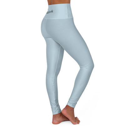 Angled rear-side view of woman wearing pastel blue Soft & Sleek leggings with slight twist in pose