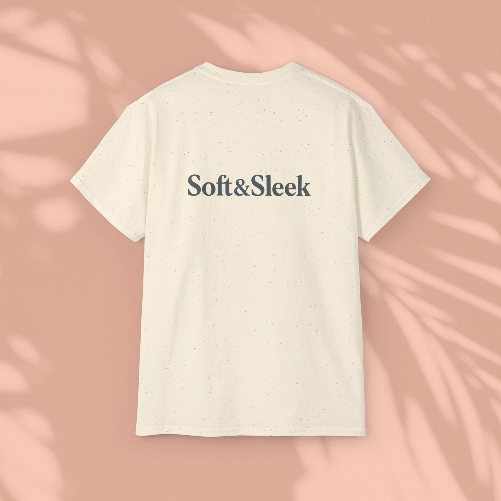 Cream Soft & Sleek t-shirt with logo on back, peach background