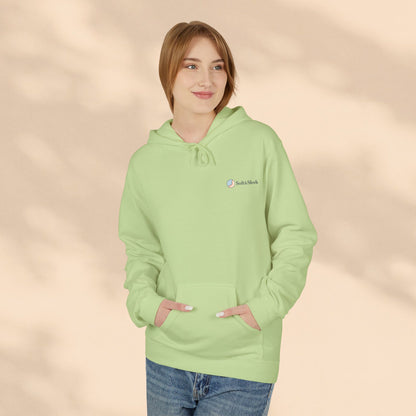 Person wearing a light green hoodie with a logo on a beige background