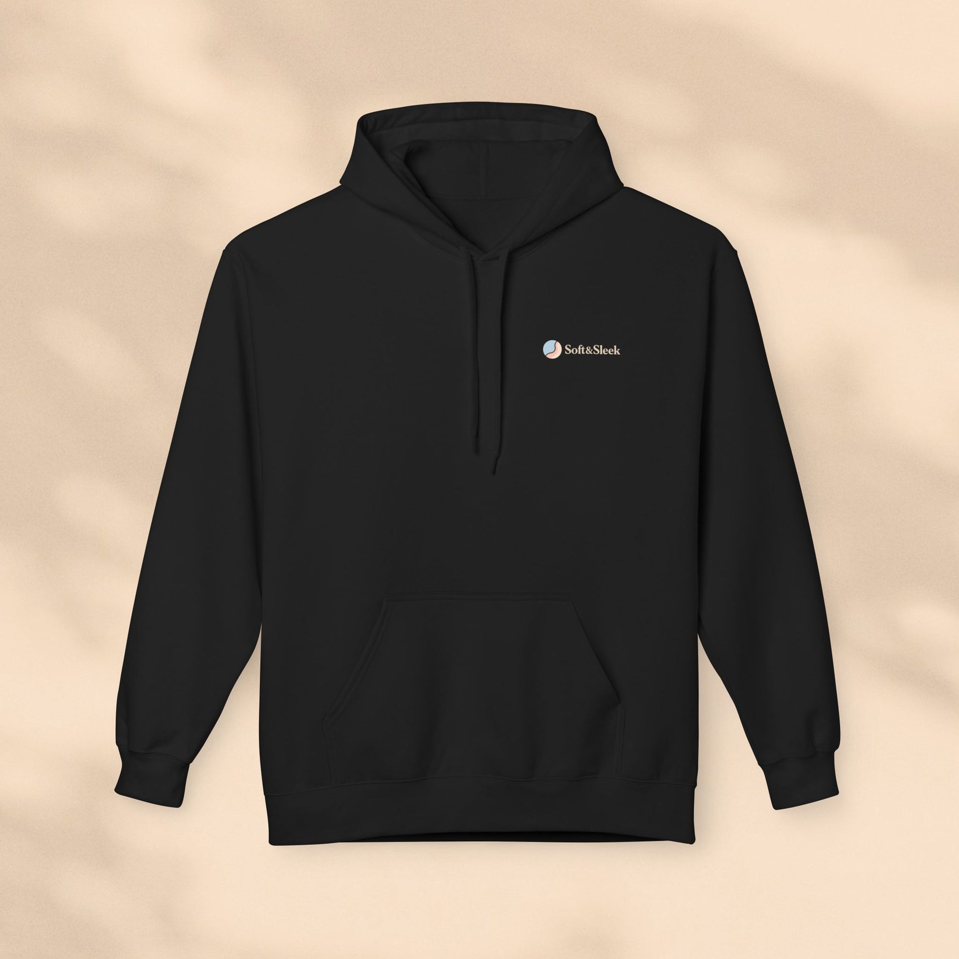 Black hoodie with a logo on a beige background