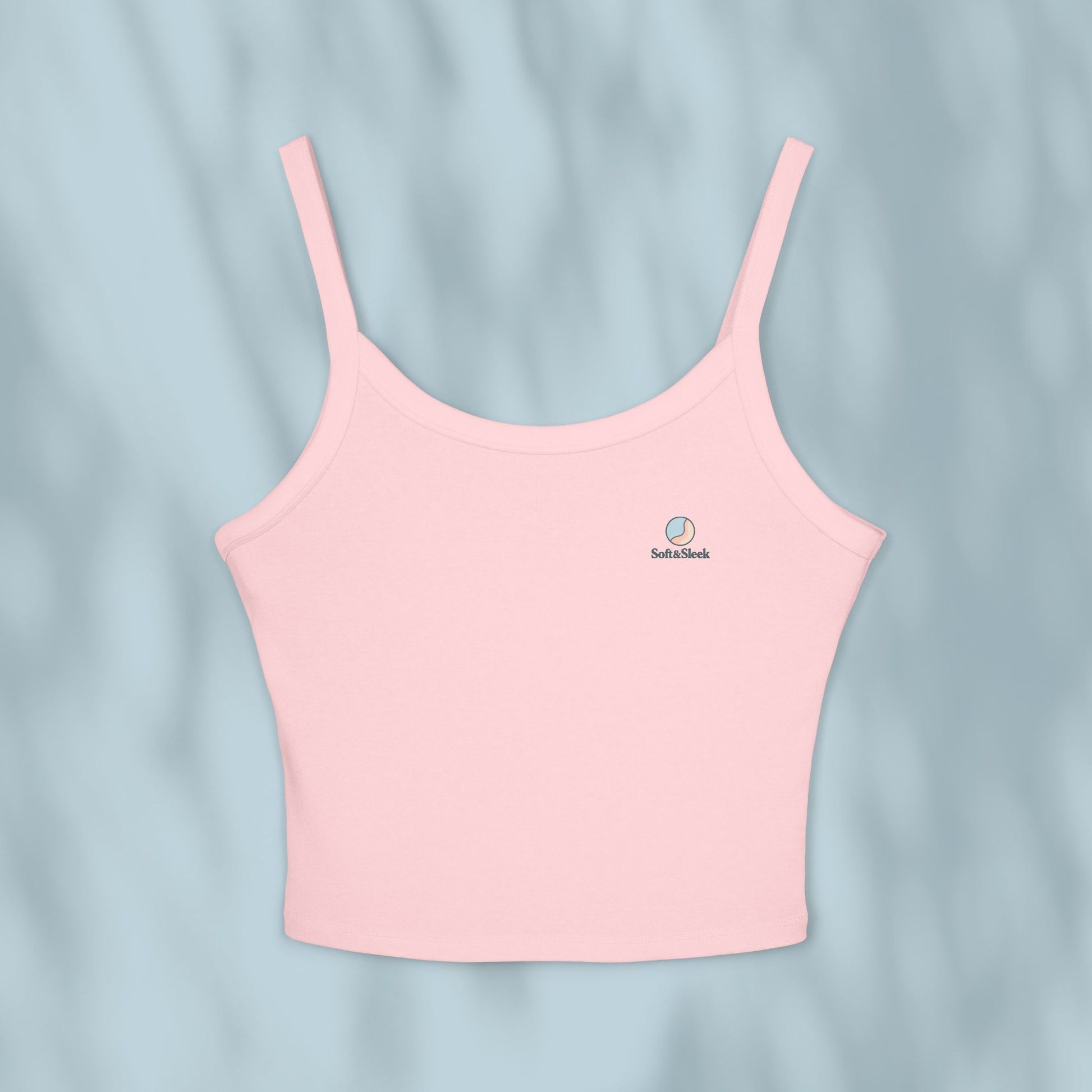 Pink tank top with a brand logo on a light blue background