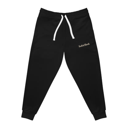 Flat lay front view of black Soft & Sleek joggers with cuffed ankles and visible drawstring.