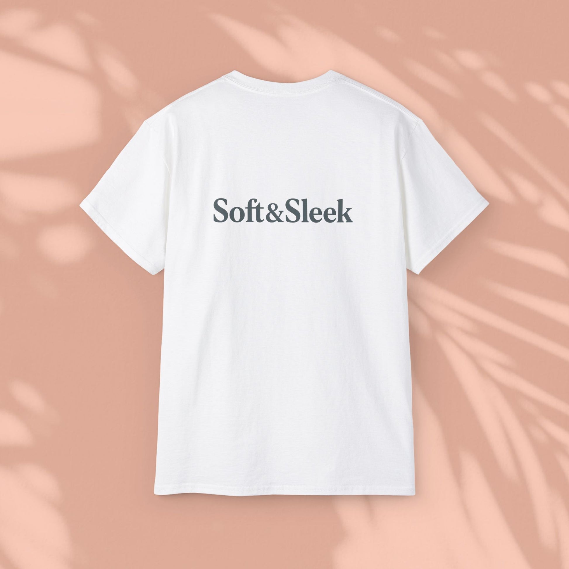 White Soft & Sleek t-shirt with logo on back, peach background