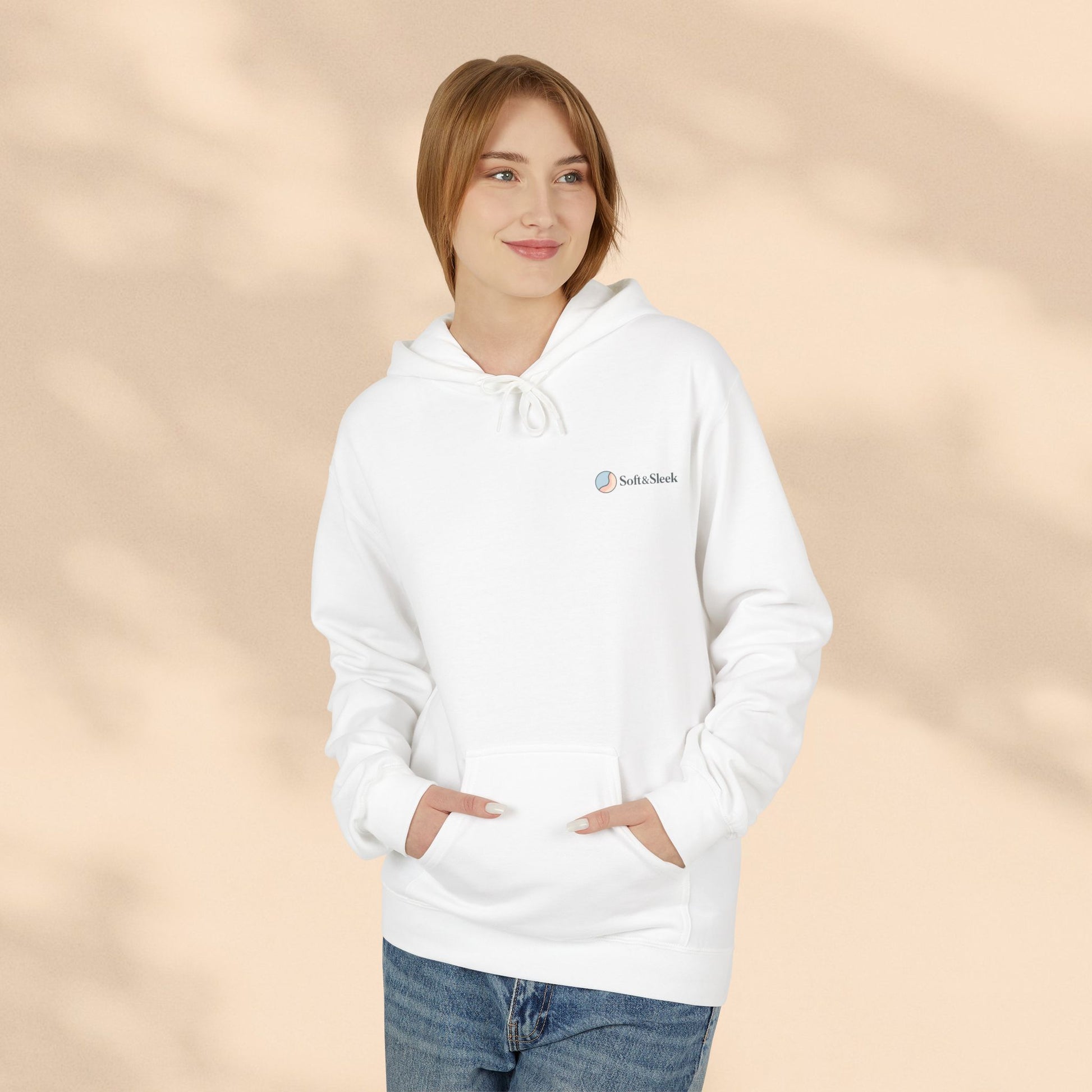 Person wearing a white hoodie with a logo on a beige background