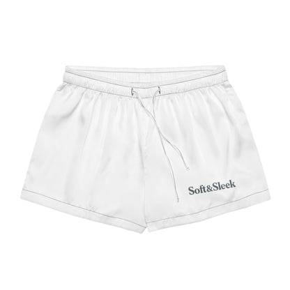 Flat lay of white Soft & Sleek shorts with front-facing view, drawstring and logo visible on the leg.