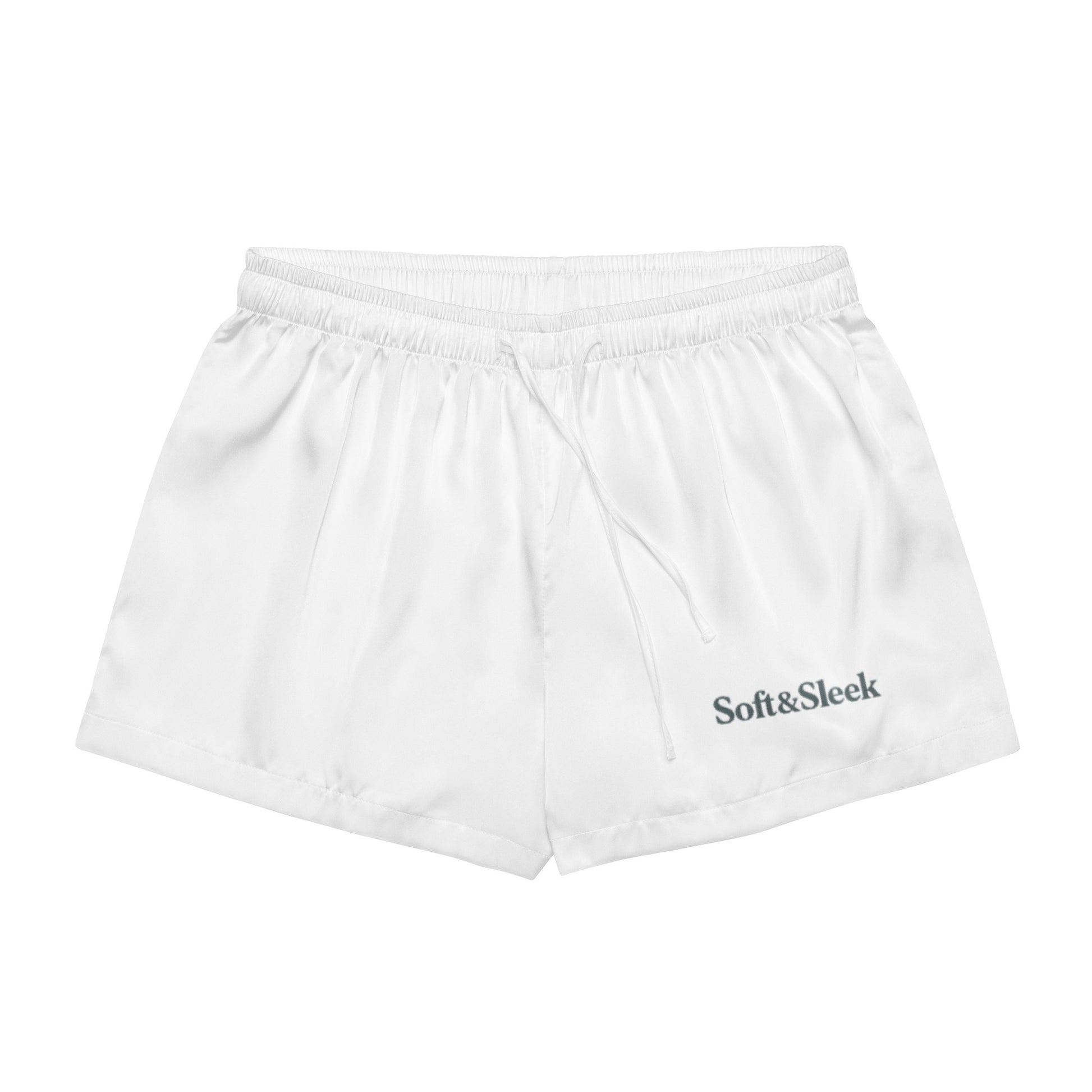 Flat lay of white Soft & Sleek lounge shorts with logo printed on the lower leg, front-facing.