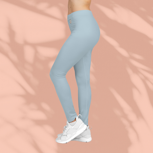 Side view of light blue Soft & Sleek leggings on model, showing smooth fit and mid-step pose, peach background