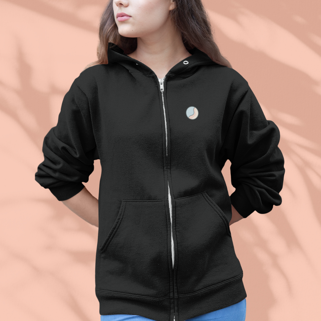 Black zip-up hoodie with a small logo on a peach background